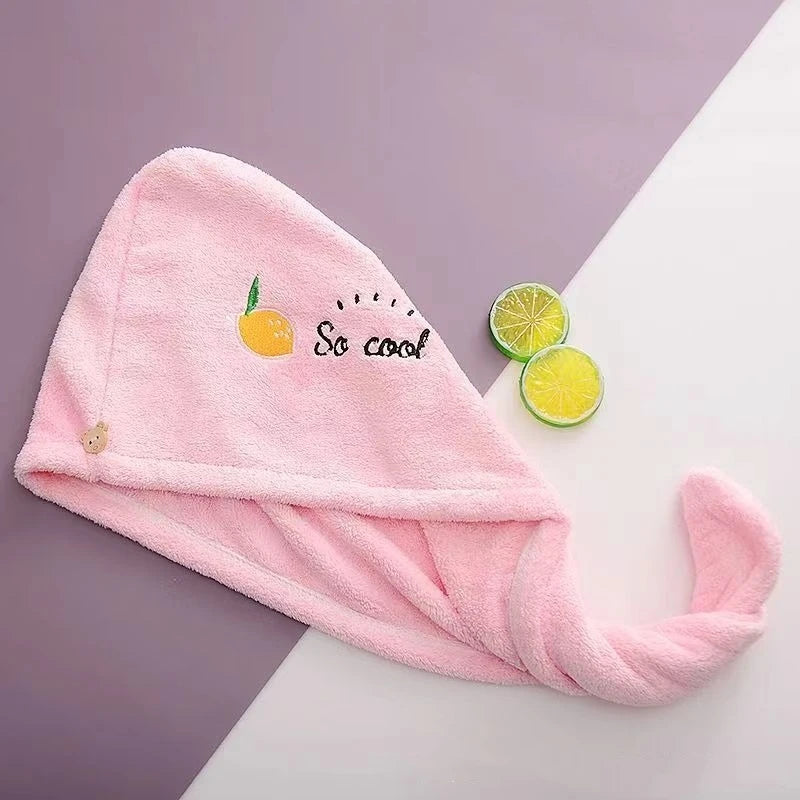 Pink towel with 'So cool' text and lemon graphics on a purple and white background
