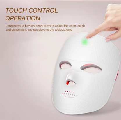 White LED facial therapy mask with a hand touching its touch control surface, shown with instructional text on a soft pink background.