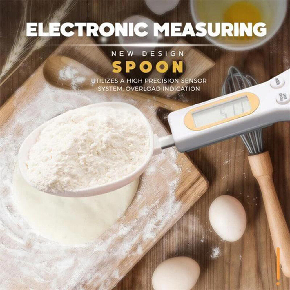 Electronic measuring spoon being used to measure flour on a wooden surface with eggs and a whisk.