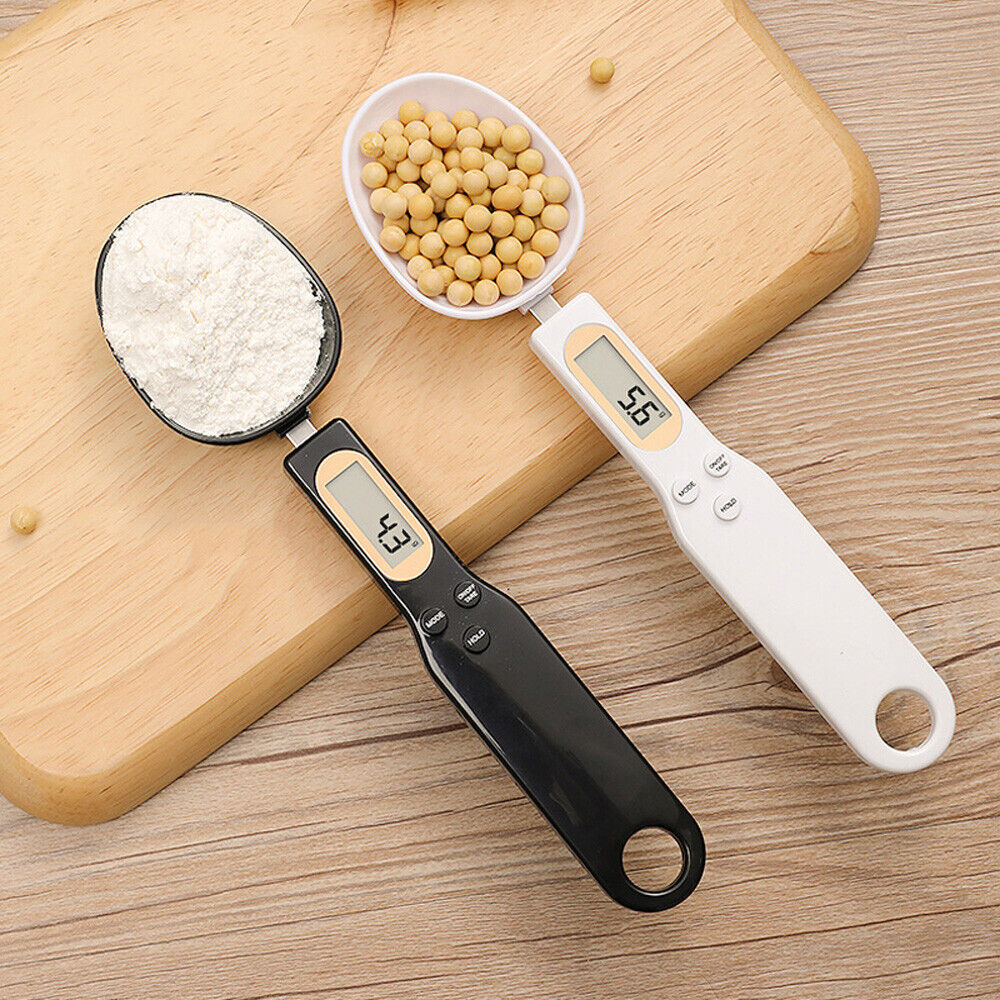 Digital measuring spoons with ingredients on a wooden surface