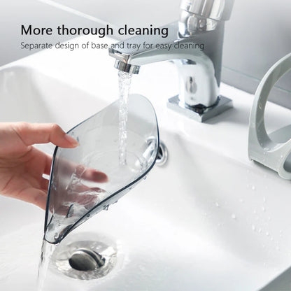 Clear glass tray being rinsed under running water in a sink with text about cleaning design.