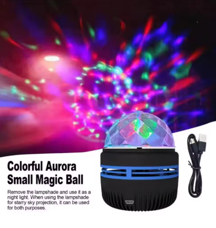 A small black and blue portable magic ball night light with a faceted dome top, shown with a USB charging cable on a white background. The top half of the image displays colorful starry sky projections, and text on the bottom left reads 'Colorful Aurora Small Magic Ball'.