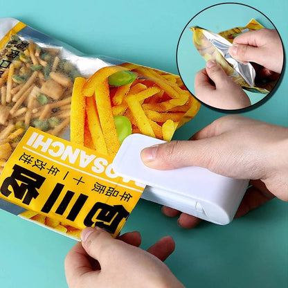 Person using a small white device to open a package of snacks with a blue background