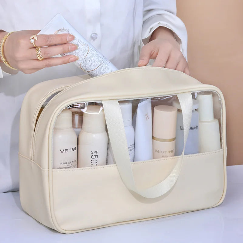 Beige toiletry bag with skincare products inside, held by a person.