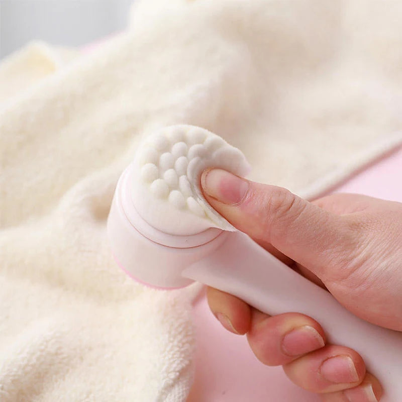Close-up of the pink facial brush being used with foam