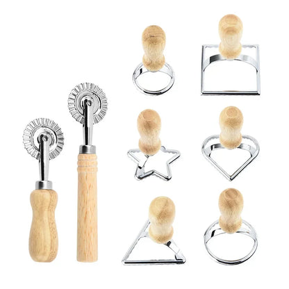 Set of cookie cutters with wooden handles on a white background