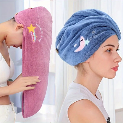 Two women wearing colorful towel turbans with cartoon designs against a white curtain background.