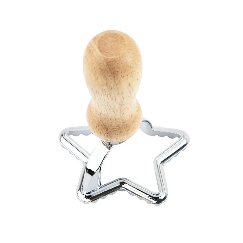 Star-shaped cookie cutter with wooden handle on a white background