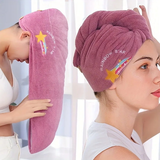 A woman modeling a pink towel wrap headscarf, shown both wrapped around her head and laid flat. The towel features a yellow shooting star graphic with the text 'RAINBOW STAR'.