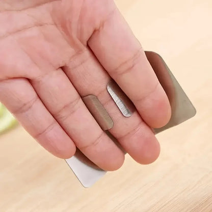 Hand holding a small metallic object on a wooden surface