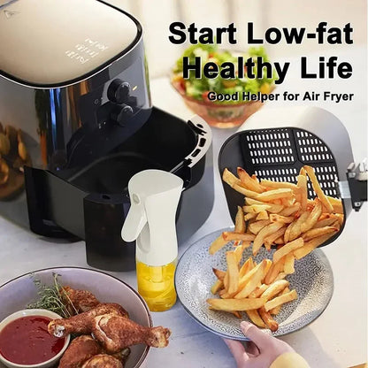 Air fryer with cooked french fries on a plate, surrounded by food items and a bottle of oil.