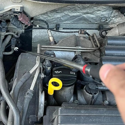 Person working on a car engine with tools