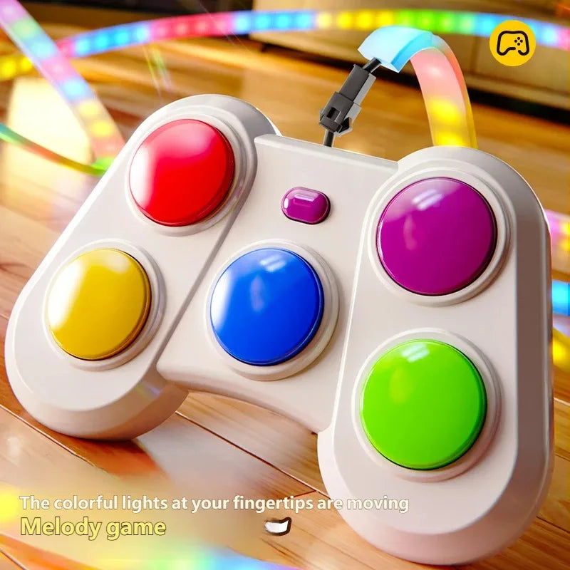 A handheld game controller with large colorful buttons in red, yellow, blue, purple, and green, shown on a wooden surface with glowing multicolor light effects in the background. Text at the bottom reads, 'The colorful lights at your fingertips are moving Melody game.