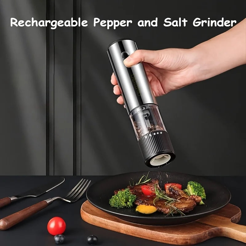 Hand holding a rechargeable pepper and salt grinder over a plate of food with utensils on a dark surface.