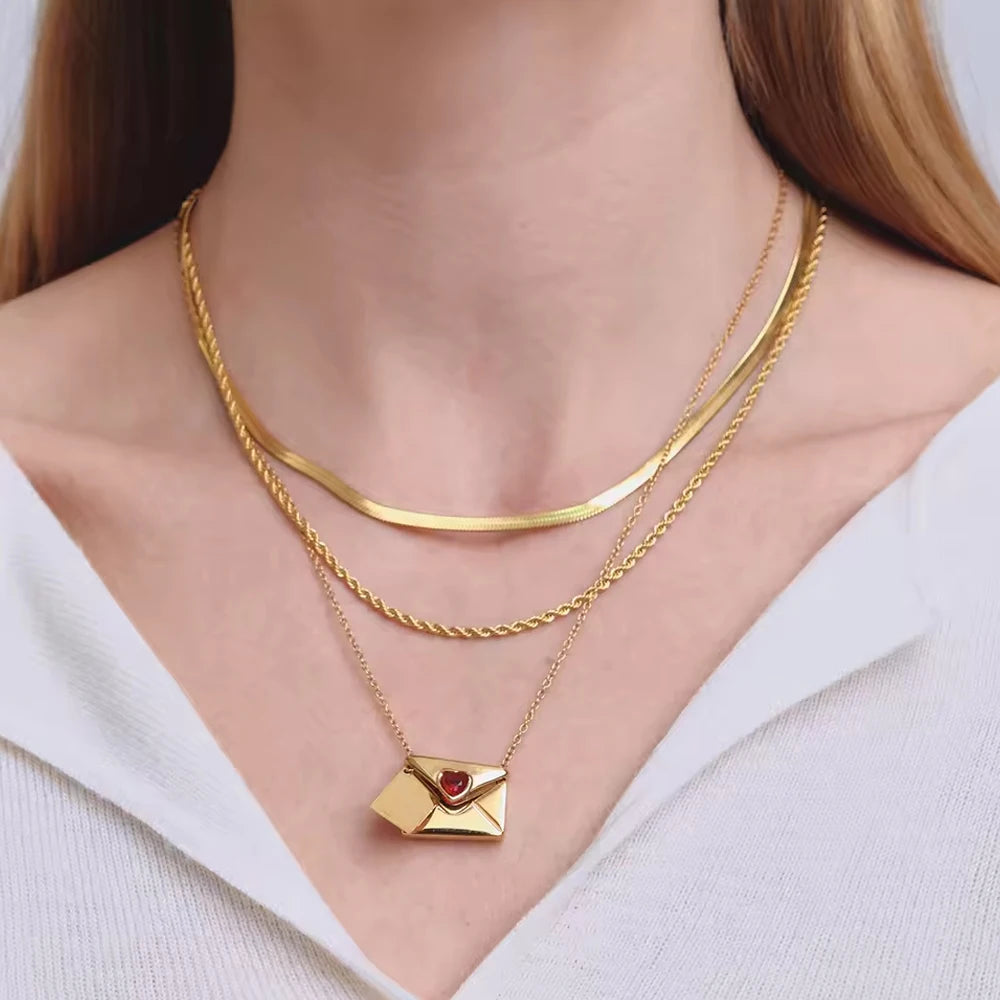 Gold necklaces with a heart-shaped pendant on a white background