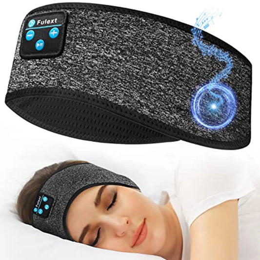 Gray sleep mask with Bluetooth control panel worn by a person sleeping