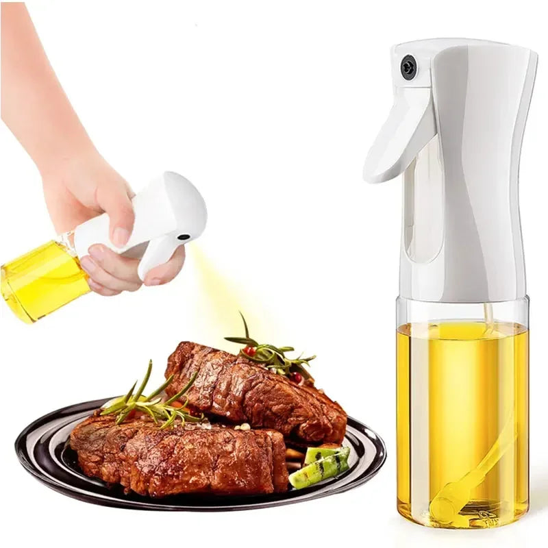 Olive oil sprayer being used to drizzle oil over cooked meat and vegetables on a plate.