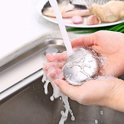 a person washing their hands under running water using the Steel Soap Bar