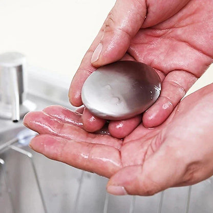 Hand holding a bar of soap with a blurred bathroom background