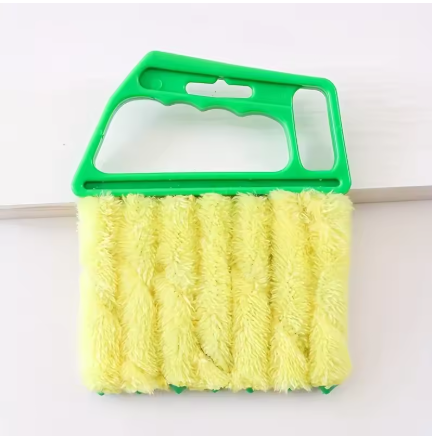 A yellow microfiber cleaning brush with a bright green plastic handle, shown against a plain white background.